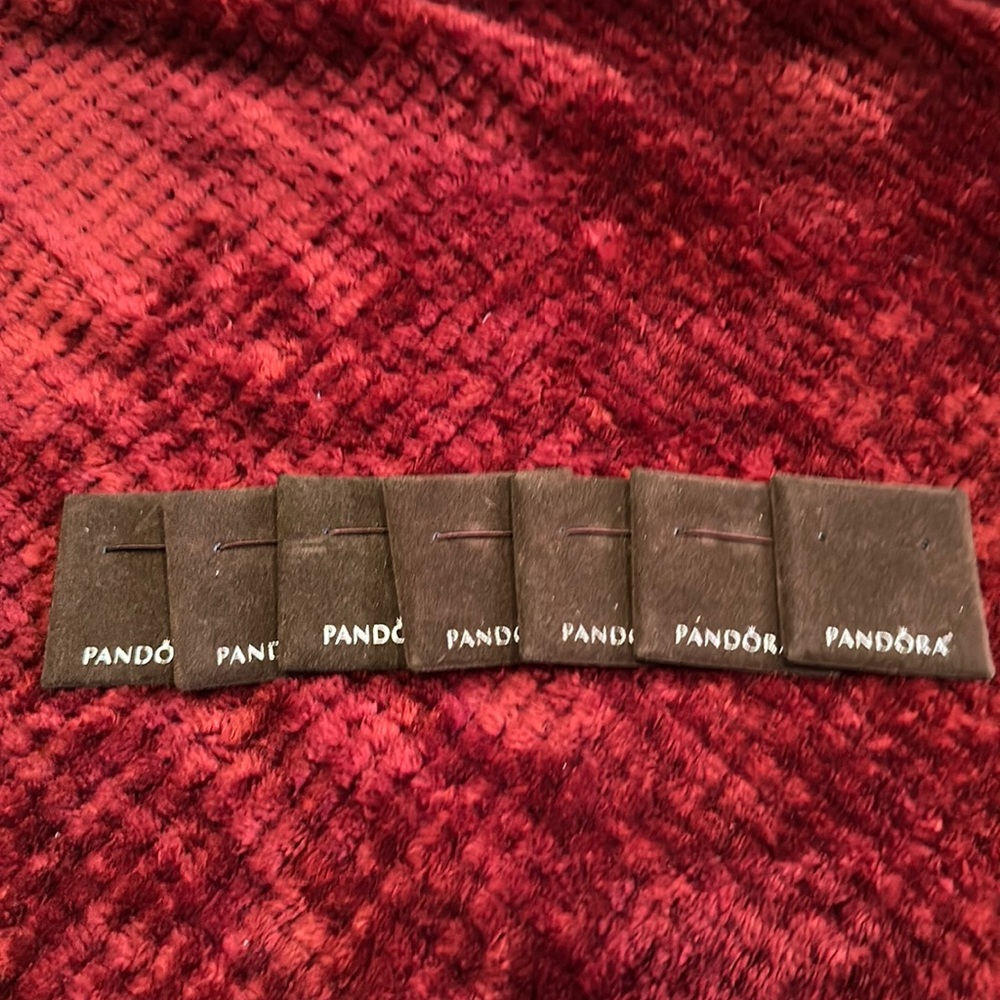 A set of 7 brown Pandora jewelry display pads.